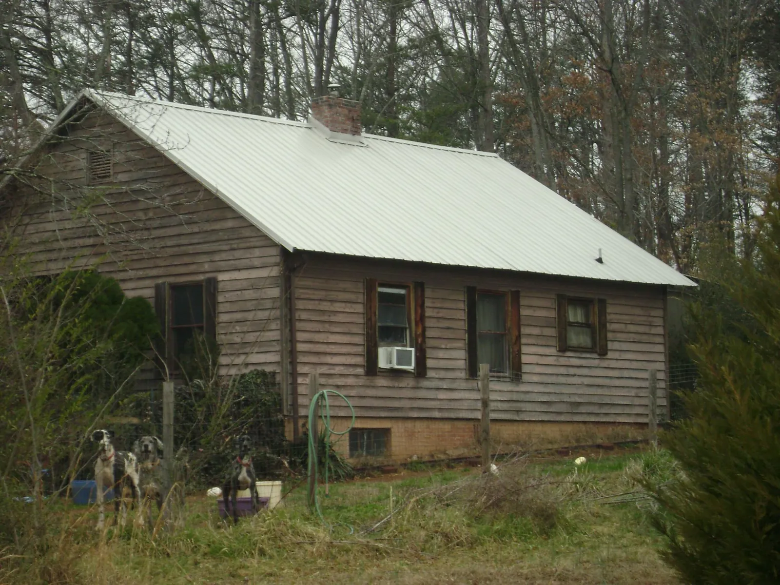White metal roof on an old wood sided farmhouse, from a Metal Roof Installation job in Westmont